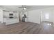 Bright, open living space featuring modern floors and access to the kitchen at 6713 Violet Cascade Ave, Las Vegas, NV 89156
