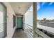 Exterior balcony with railing overlooking parking and lush landscaping at 7100 Pirates Cove Rd # 2076, Las Vegas, NV 89145