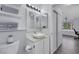 Stylish bathroom with white vanity, modern lighting, and tile flooring connected to bedroom at 7100 Pirates Cove Rd # 2076, Las Vegas, NV 89145