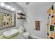 Bathroom featuring modern vessel sink, shelves, toilet, and gray walls at 7100 Pirates Cove Rd # 2076, Las Vegas, NV 89145