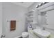 Updated bathroom featuring a decorative mirror, vessel sink, and floating shelves at 7100 Pirates Cove Rd # 2076, Las Vegas, NV 89145
