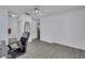 Bright bedroom featuring neutral walls, ceiling fan, gray wood floors, and adjacent bathroom at 7100 Pirates Cove Rd # 2076, Las Vegas, NV 89145
