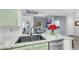 Open kitchen featuring stainless dishwasher, black sink, and granite countertops at 7100 Pirates Cove Rd # 2076, Las Vegas, NV 89145