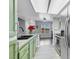 Modern kitchen featuring stainless appliances, light green cabinets, and stone countertops at 7100 Pirates Cove Rd # 2076, Las Vegas, NV 89145