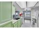 Updated kitchen featuring modern stainless steel appliances and light green cabinets at 7100 Pirates Cove Rd # 2076, Las Vegas, NV 89145