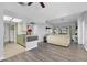 Bright, modern living room that flows into the kitchen with neutral decor and gray wood floors at 7100 Pirates Cove Rd # 2076, Las Vegas, NV 89145