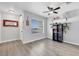 Living room view with gray wood floors, neutral decor, and plenty of natural light at 7100 Pirates Cove Rd # 2076, Las Vegas, NV 89145
