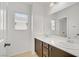 Bright bathroom features a double sink vanity with dark wood cabinets and a window at 7263 Pepperbox Ave, Las Vegas, NV 89179