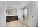 Bathroom featuring double vanity, a large mirror, separate tub, and shower with glass door at 7263 Pepperbox Ave, Las Vegas, NV 89179