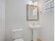 Cozy powder room with pedestal sink, large mirror, and tiled floor at 7263 Pepperbox Ave, Las Vegas, NV 89179