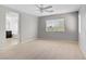 A neutral bedroom featuring a ceiling fan and natural light from the window at 7263 Pepperbox Ave, Las Vegas, NV 89179