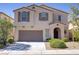 Two-story stucco home featuring a two-car garage, desert landscaping, and covered front entry at 7263 Pepperbox Ave, Las Vegas, NV 89179