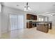Open concept kitchen with stainless steel appliances, dark cabinetry, and a central island at 7263 Pepperbox Ave, Las Vegas, NV 89179