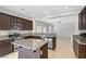 Well-lit kitchen featuring granite counters, stainless appliances, and a central island at 7263 Pepperbox Ave, Las Vegas, NV 89179