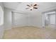 Unstaged living area with tiled flooring, ceiling fan, and a small architectural alcove for media at 7263 Pepperbox Ave, Las Vegas, NV 89179
