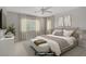 Staged primary bedroom featuring a large window, ceiling fan and neutral decor at 7263 Pepperbox Ave, Las Vegas, NV 89179