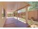 The covered patio features decorative landscaping, artificial turf, and an enclosed block fence at 7263 Pepperbox Ave, Las Vegas, NV 89179