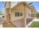 The covered patio features decorative landscaping, artificial turf, and an enclosed block fence at 7263 Pepperbox Ave, Las Vegas, NV 89179