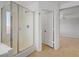 Bright bathroom with a glass-enclosed shower, neutral tile, and access to bedroom at 7263 Pepperbox Ave, Las Vegas, NV 89179