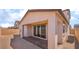 A spacious backyard with a covered patio, featuring brick pavers, offering an inviting outdoor space for relaxation at 765 Cloud Creek St, Henderson, NV 89011