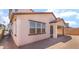 A view of the home's backyard featuring a covered patio and large windows, perfect for outdoor living and entertaining at 765 Cloud Creek St, Henderson, NV 89011