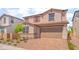 Charming two-story home with a brick driveway, stone accents, desert landscaping, and neutral color palette at 765 Cloud Creek St, Henderson, NV 89011