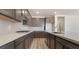 Well-equipped kitchen featuring stainless steel appliances, gray cabinets, a large island, and a quartz countertop at 765 Cloud Creek St, Henderson, NV 89011