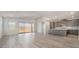 Bright living room featuring gray cabinets, an island, an open floor plan, and a large glass sliding door at 765 Cloud Creek St, Henderson, NV 89011