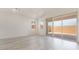 Bright living room featuring gray cabinets, an island, an open floor plan, and a large glass sliding door at 765 Cloud Creek St, Henderson, NV 89011