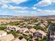 Expansive aerial view of a residential neighborhood with mountain views under a partly cloudy sky at 7854 Brianna Cheerful Ave, Las Vegas, NV 89178