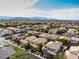 Community shot showing diverse home styles nestled amongst lush landscaping with mountain views at 7854 Brianna Cheerful Ave, Las Vegas, NV 89178