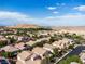 Wide aerial shot of a residential community featuring numerous single-Gathering homes and desert landscape at 7854 Brianna Cheerful Ave, Las Vegas, NV 89178