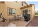 Cozy back patio with dining table, seating, grill, and sliding glass door access to indoors at 7854 Brianna Cheerful Ave, Las Vegas, NV 89178