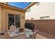 Outdoor dining set with a grill on a covered patio that provides a cozy backyard experience at 7854 Brianna Cheerful Ave, Las Vegas, NV 89178