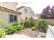 Landscaped backyard featuring lush greenery, mature trees, and privacy fence for tranquil outdoor living at 7854 Brianna Cheerful Ave, Las Vegas, NV 89178