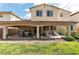 Spacious backyard with lush lawn and covered patio, ideal for outdoor living and entertaining at 7854 Brianna Cheerful Ave, Las Vegas, NV 89178