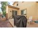 Back patio featuring a grill, outdoor seating, and access to a well-maintained backyard space at 7854 Brianna Cheerful Ave, Las Vegas, NV 89178