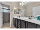 Bathroom with double vanity, tile floors, and framed mirrors at 7854 Brianna Cheerful Ave, Las Vegas, NV 89178