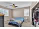 Comfortable bedroom with a ceiling fan, closet, and cozy bedding, bathed in natural light from the window at 7854 Brianna Cheerful Ave, Las Vegas, NV 89178