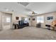 Spacious carpeted bedroom featuring neutral paint, large windows, and a ceiling fan at 7854 Brianna Cheerful Ave, Las Vegas, NV 89178