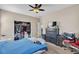 Cozy bedroom with ceiling fan, dark wood dresser, closet, and carpeted floor at 7854 Brianna Cheerful Ave, Las Vegas, NV 89178