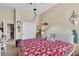 Inviting bedroom with a red floral comforter, nautical accents, and a closet at 7854 Brianna Cheerful Ave, Las Vegas, NV 89178