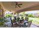 Inviting covered patio featuring a ceiling fan, dining set, and relaxing backyard views for outdoor entertaining at 7854 Brianna Cheerful Ave, Las Vegas, NV 89178