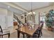 Dining room with a wooden table, stylish chandelier, and neutral color palette at 7854 Brianna Cheerful Ave, Las Vegas, NV 89178