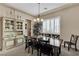 Elegant dining room featuring a rustic wooden table, stylish chandelier, and decorative hutch at 7854 Brianna Cheerful Ave, Las Vegas, NV 89178