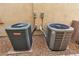 Two air conditioning units on gravel pads outside of the home's exterior at 7854 Brianna Cheerful Ave, Las Vegas, NV 89178
