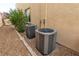 Two air conditioning units beside home, surrounded by rocks and greenery at 7854 Brianna Cheerful Ave, Las Vegas, NV 89178