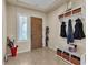 Foyer with a wood door, tile flooring, built-in storage, and natural light at 7854 Brianna Cheerful Ave, Las Vegas, NV 89178