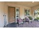 Inviting front porch with stylish seating, door, and 'Welcome' sign at 7854 Brianna Cheerful Ave, Las Vegas, NV 89178