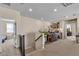 A well-lit hallway with carpeted stairs, a desk area, and open doorways to other rooms in the home at 7854 Brianna Cheerful Ave, Las Vegas, NV 89178